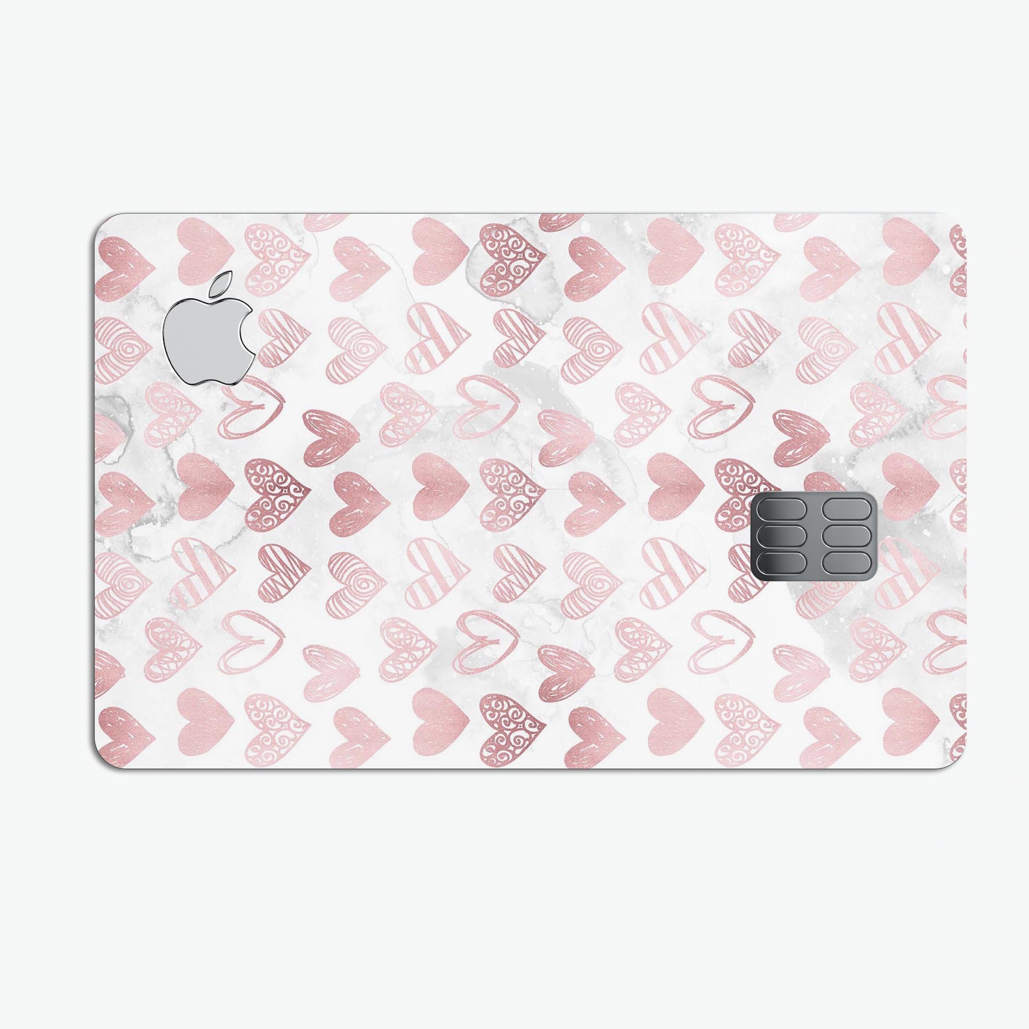 Karamfila Marble & Rose Gold Hearts v3 decal applied on an Apple Card, showcasing its elegant design and premium finish.